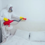 Nettoyage désinfection chambre avec équipement de protection.